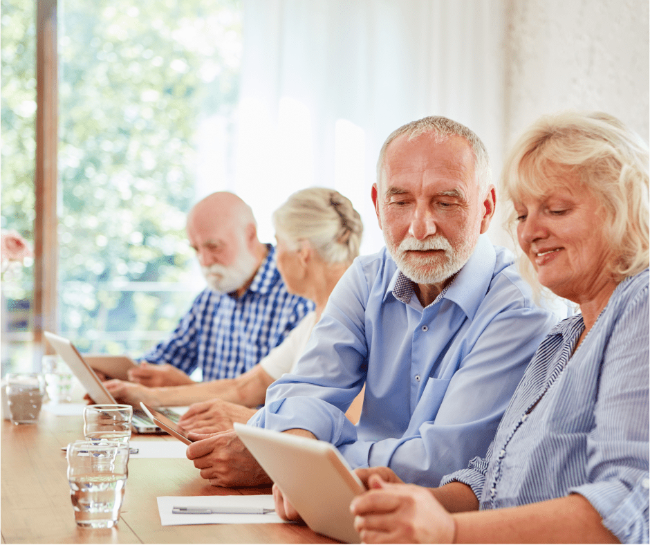 a person standing at a podium with a microphone and people sitting in chairs